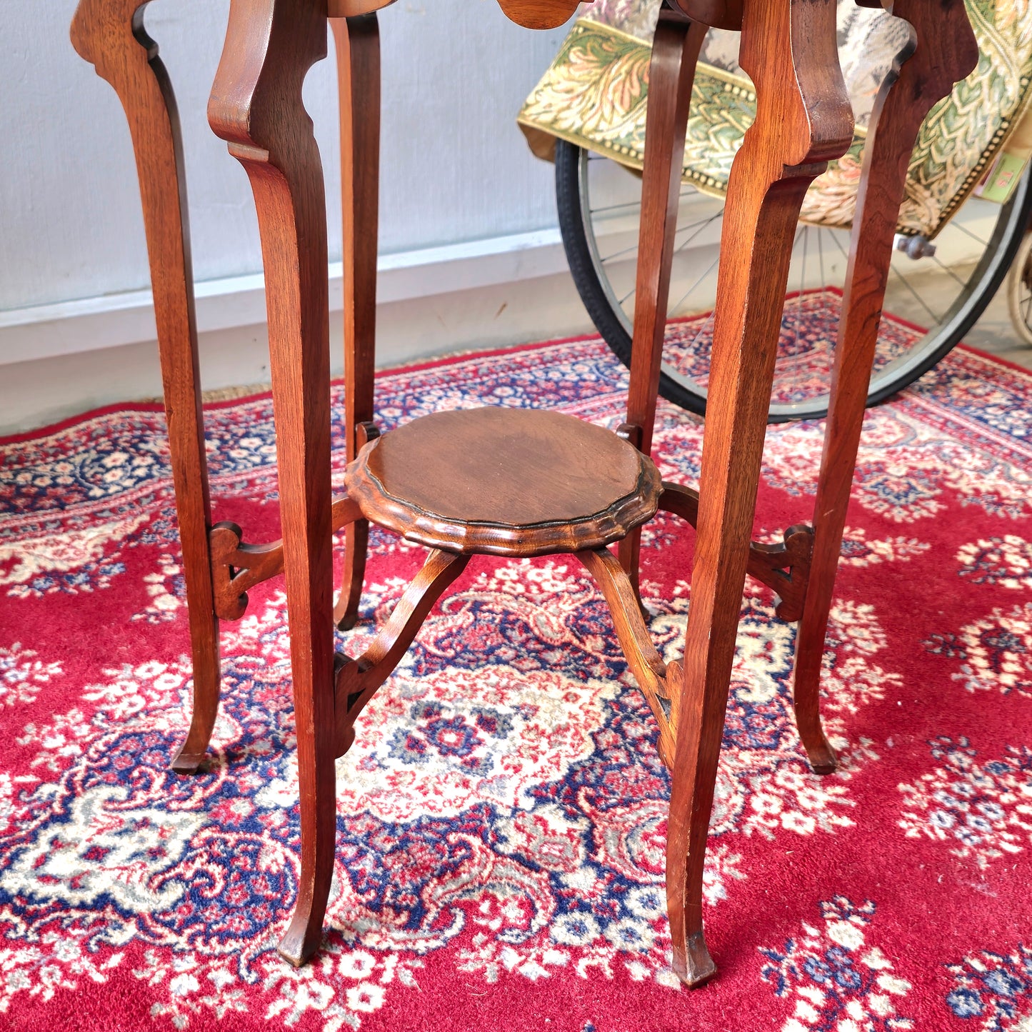 AN EDWARDIAN TWO TIER CENTRE TABLE WITH PIE-CRUST EDGE