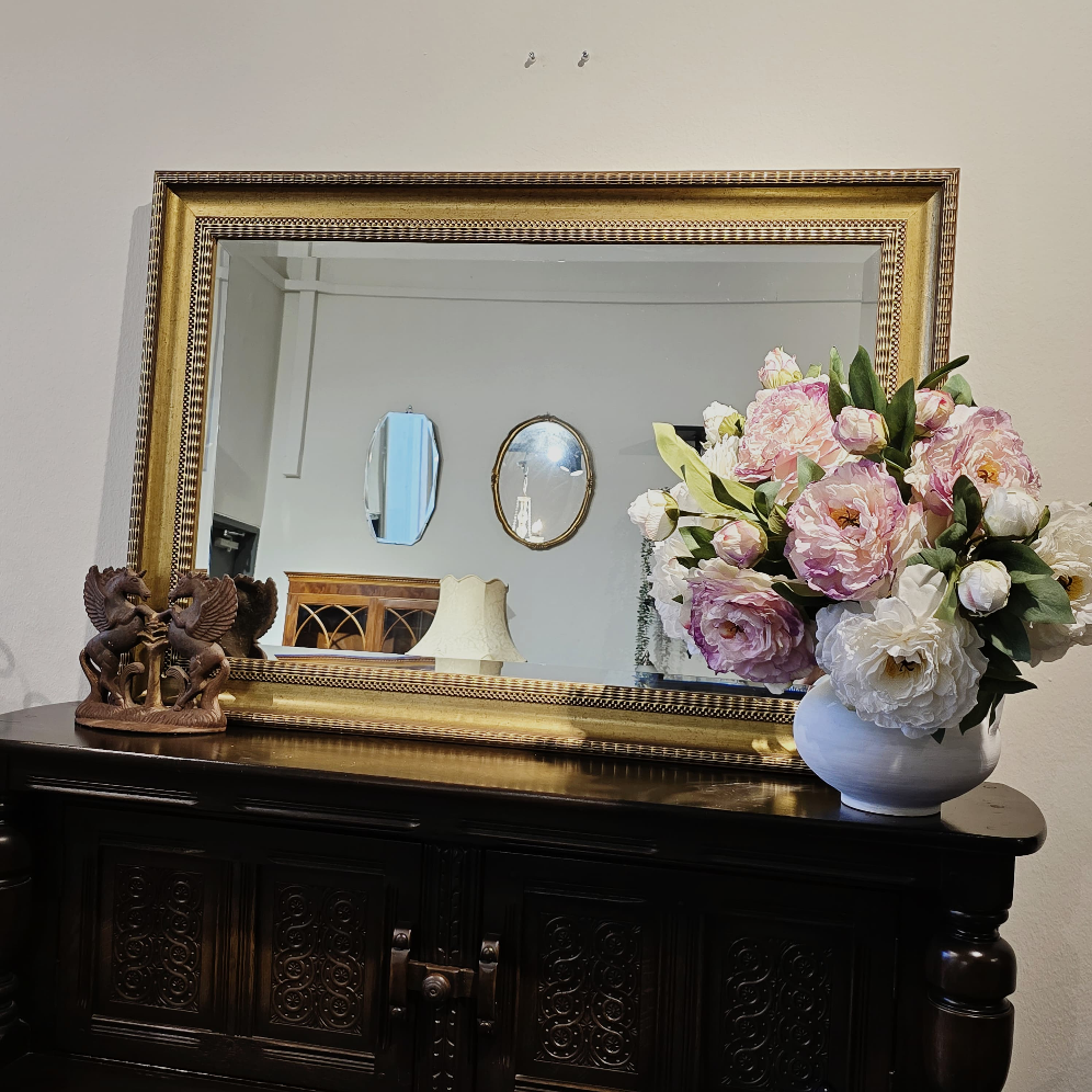A VINTAGE GILT FRAMED BEVEL EDGE WALL MIRROR