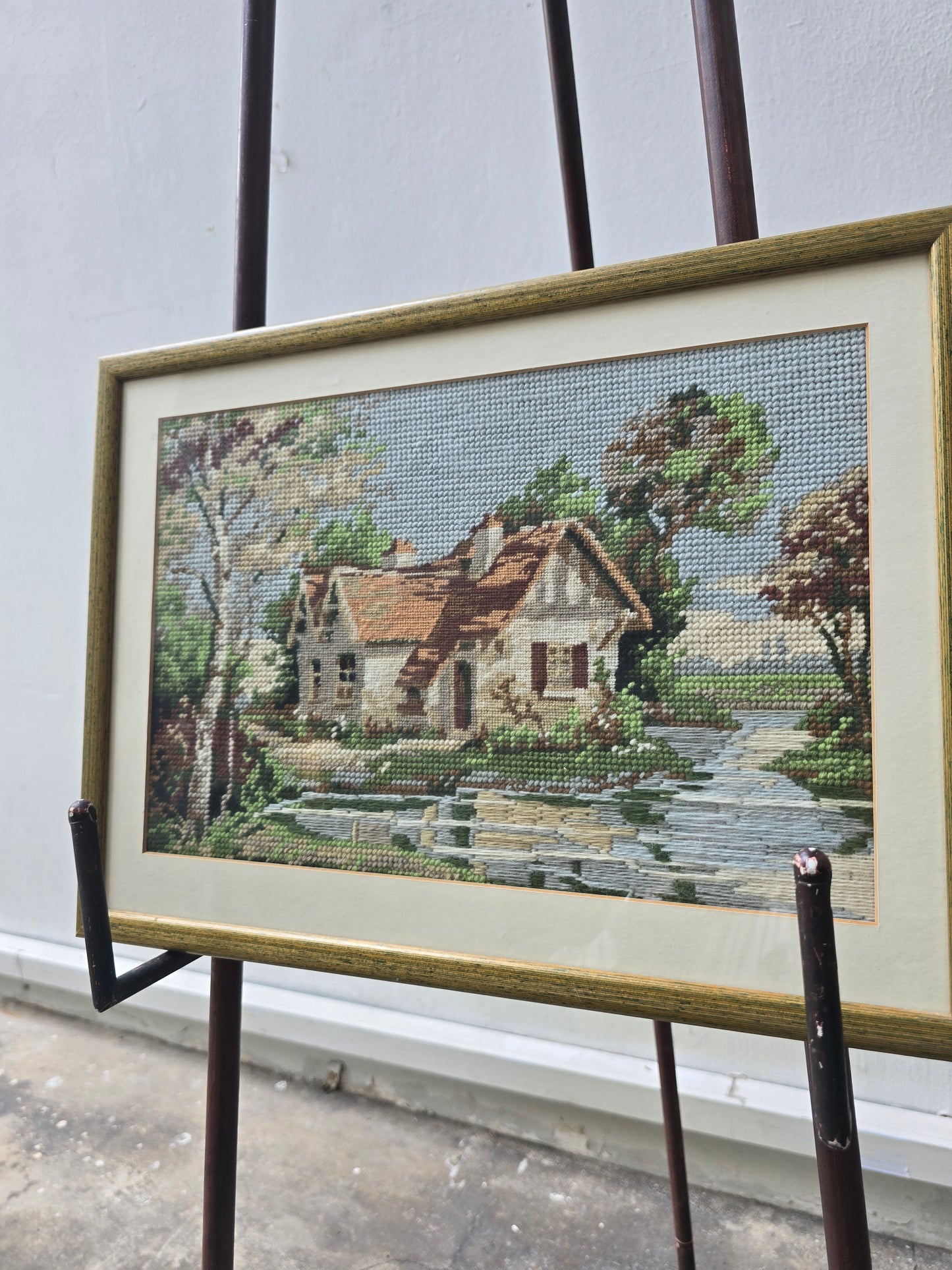 Exquisite work of needle point house on river