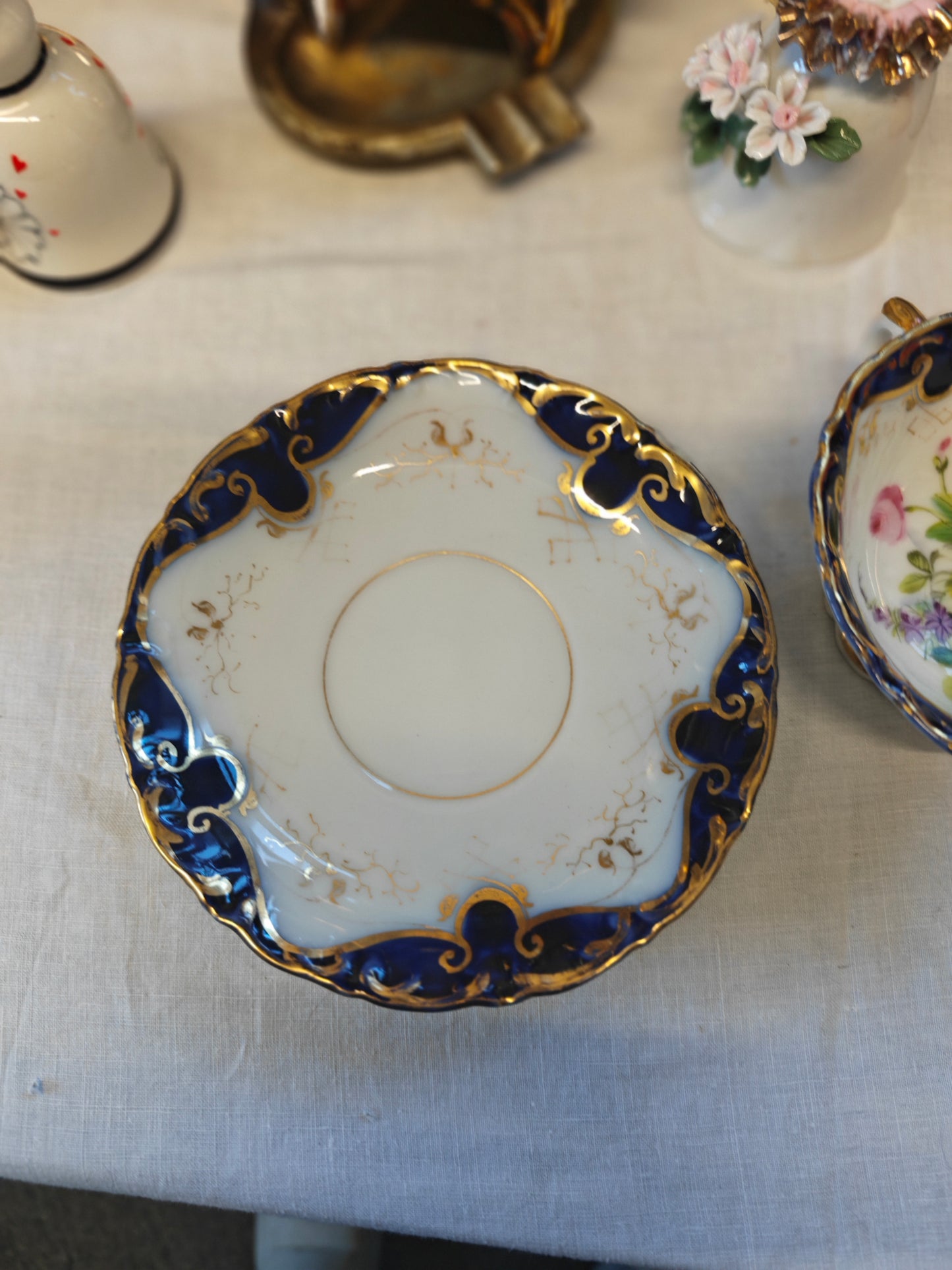 French Antique porcelain cup and saucer in rocaille style