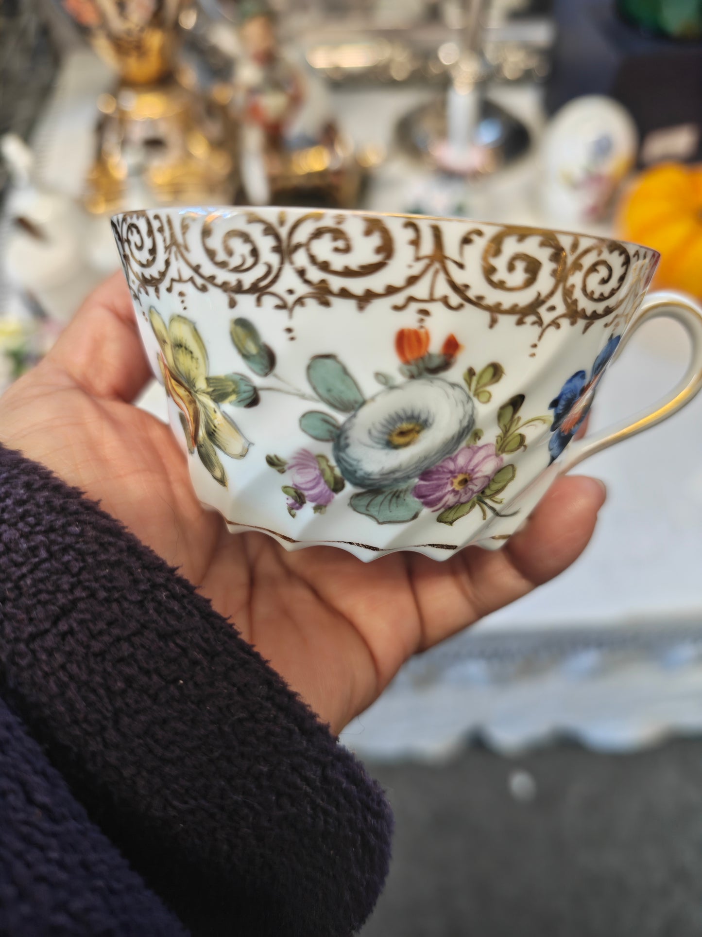 Dresden tea cup and saucer set features a delicate floral design with intricate gold accents