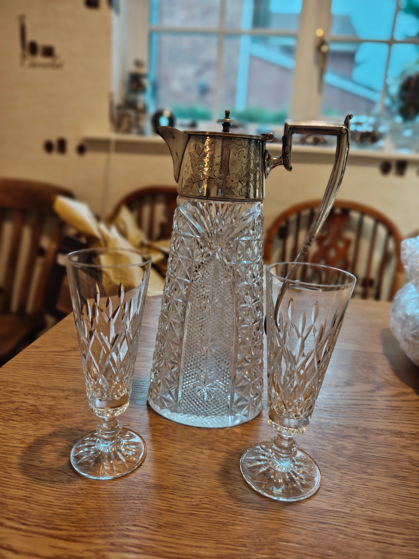 Edwardian pitcher with silver plated handle and lid. Pair with a pair of Waterford crystal glass on stem feet