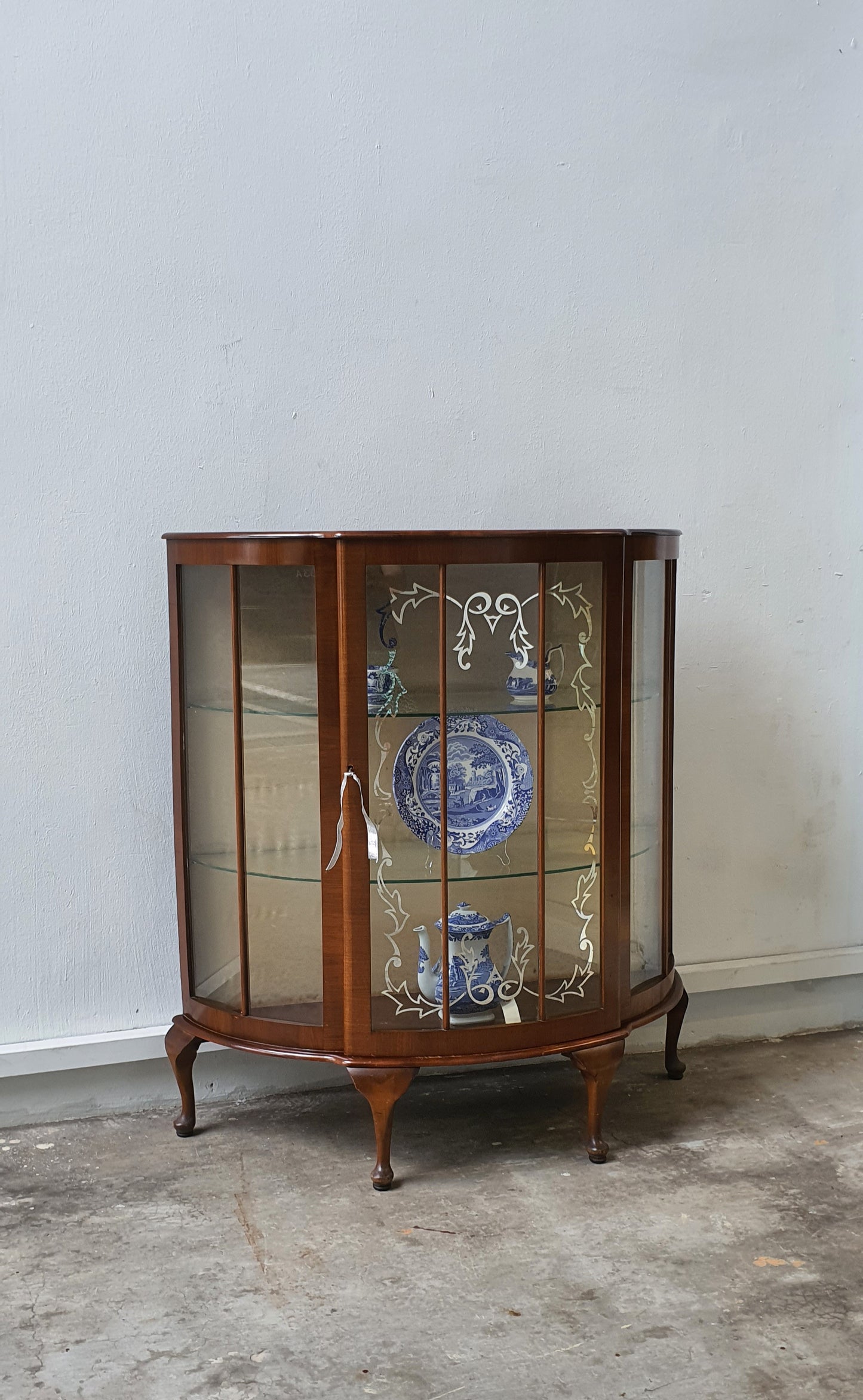 Vintage Bow Front display cabinet with pretty glass motif