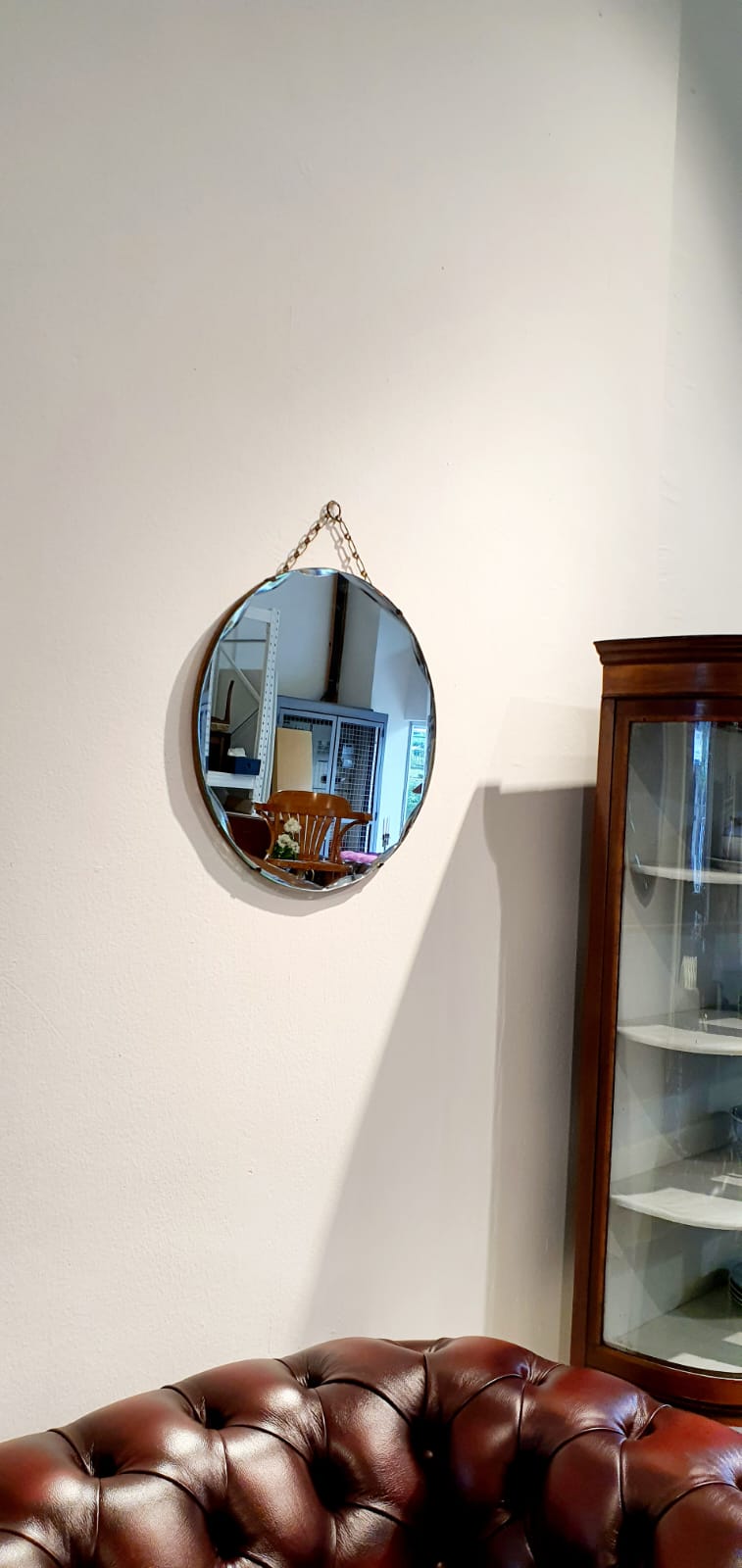 A round vintage mirror with a beveled edge