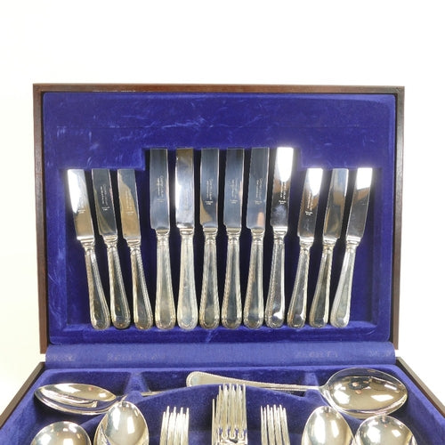 Vintage Cooper Ludlam stainless steel forty-four piece cutlery set, housed in a blue velvet-lined wooden cased box, with Rothmans Collection label on the box.