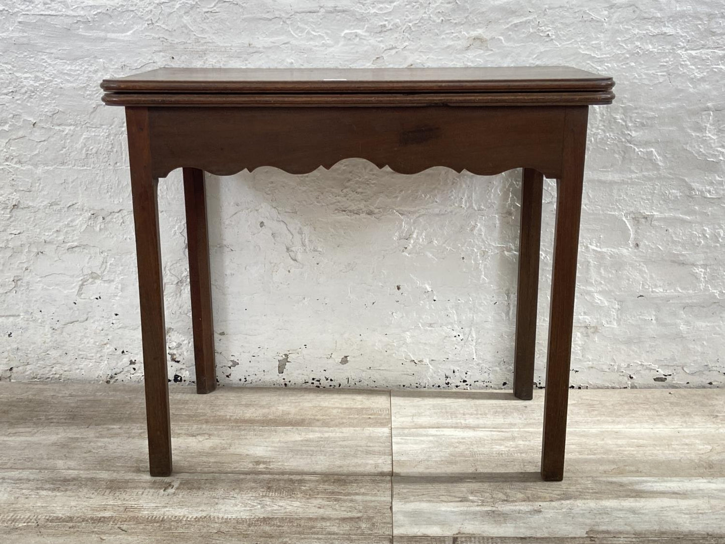 A George III mahogany fold over tea table - approx. 74cm high x 87cm wide x 42cm deep when closed