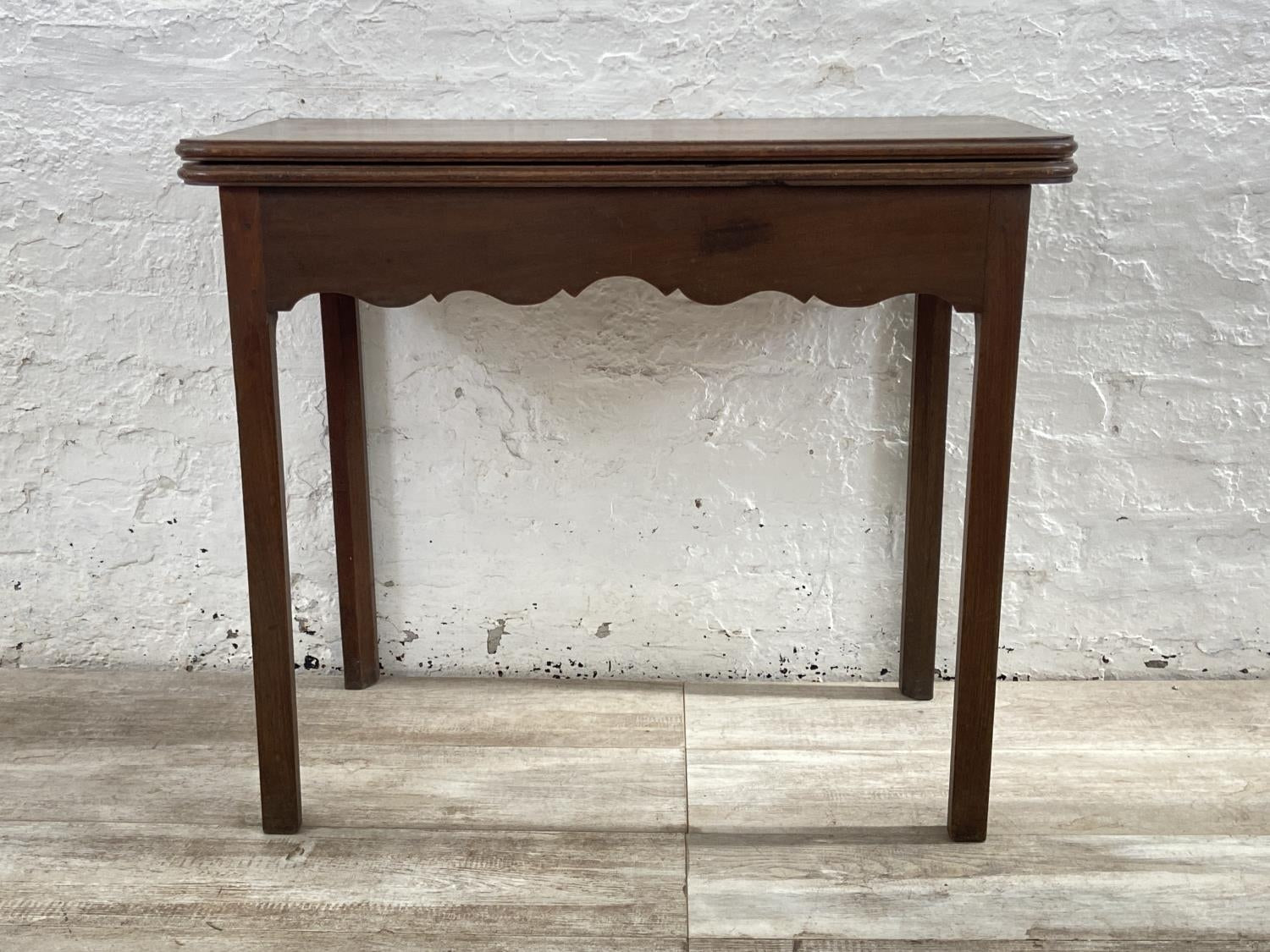 A George III mahogany fold over tea table - approx. 74cm high x 87cm wide x 42cm deep when closed