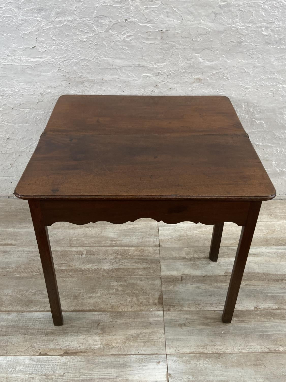 A George III mahogany fold over tea table - approx. 74cm high x 87cm wide x 42cm deep when closed