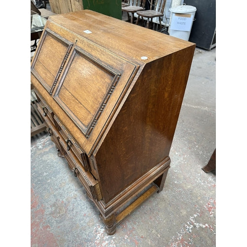 An early 20th century carved oak bureau - approx. 99cm high x 77cm wide x 45cm deep