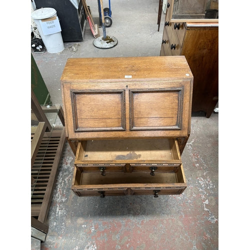 An early 20th century carved oak bureau - approx. 99cm high x 77cm wide x 45cm deep