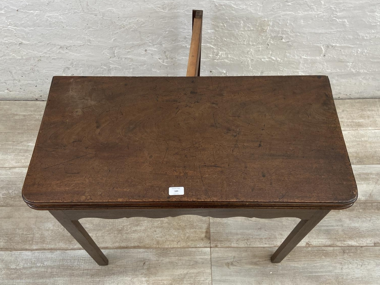 A George III mahogany fold over tea table - approx. 74cm high x 87cm wide x 42cm deep when closed