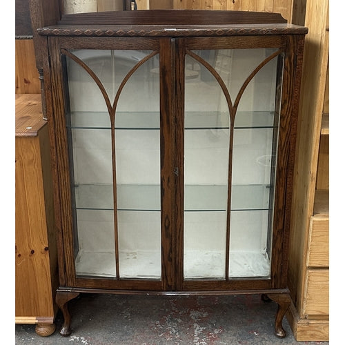 Early 20th century carved oak display cabinet with two glazed doors and cabriole supports