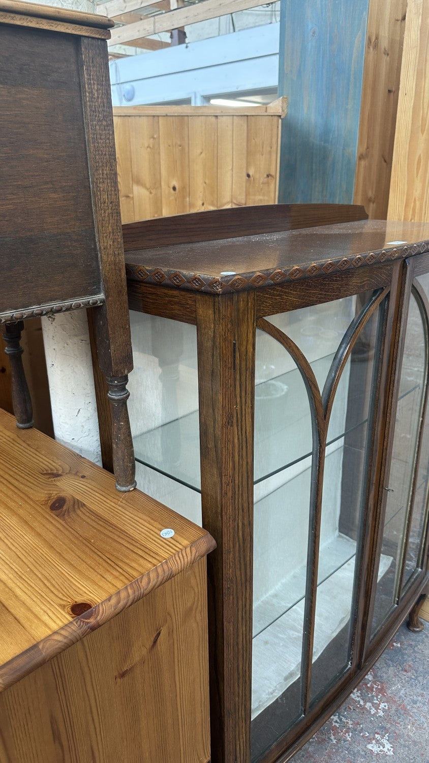 Early 20th century carved oak display cabinet with two glazed doors and cabriole supports