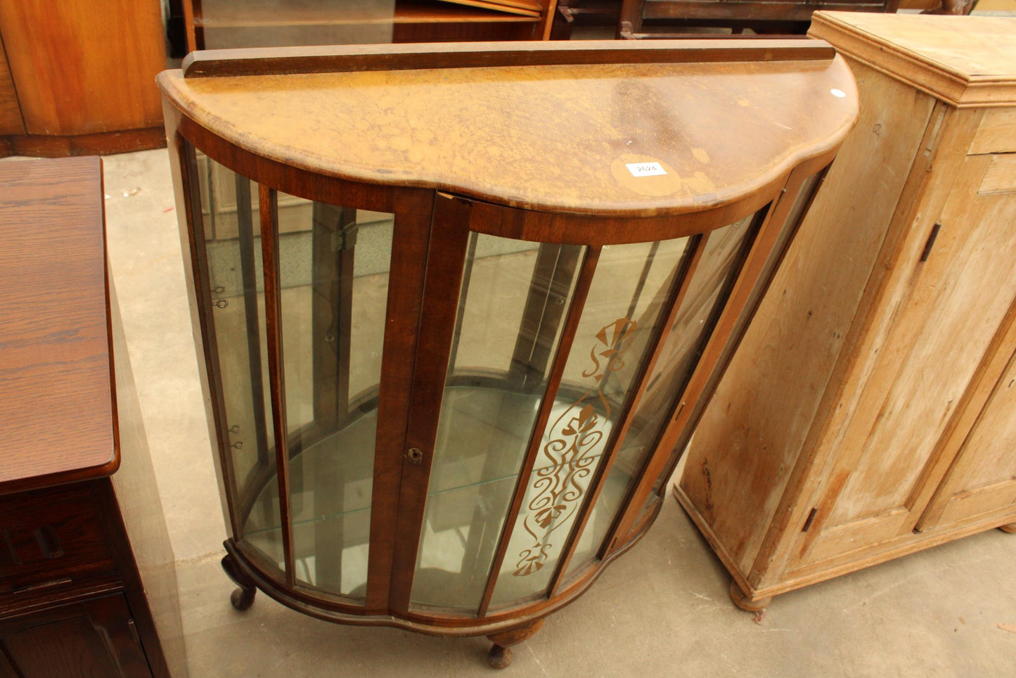 A SHINY WALNUT BOW-FRONTED CHINA CABINET ON CABRIOLE LEGS