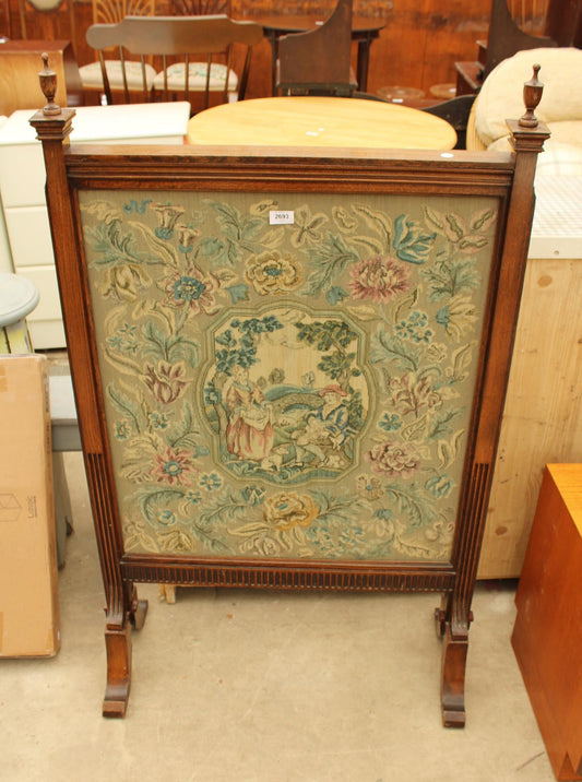 A LATE VICTORIAN OAK FIRESCREEN WITH TAPESTRY PANEL AND VASE SHAPED