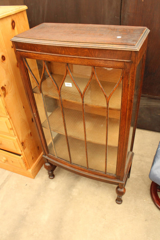 AN EARLY 20TH CENTURY OAK CHINA CUPBOARD ON OPEN BASE