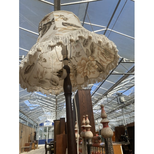 A STANDARD LAMP WITH TURNED COLUMN AND SHADE