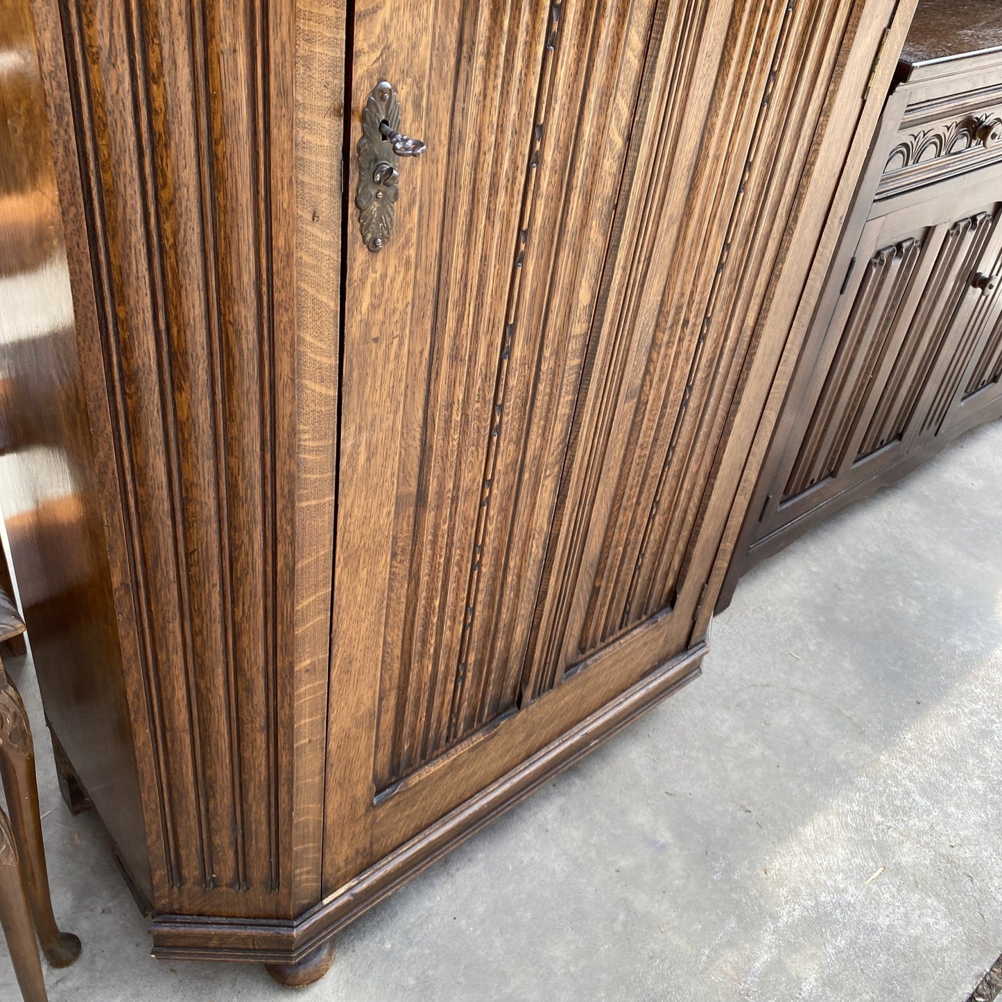 AN EARLY 20TH CENTURY OAK HALL WARDROBE WITH LINEN FOLD AND FOLIATE DECORATION 38" WIDE