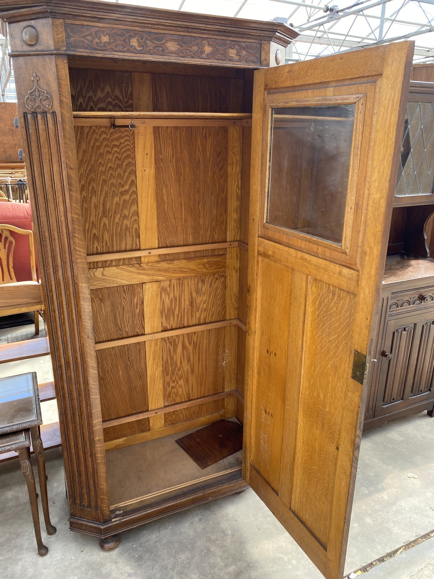 AN EARLY 20TH CENTURY OAK HALL WARDROBE WITH LINEN FOLD AND FOLIATE DECORATION 38" WIDE