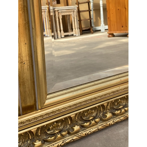 A GILT FRAMED BEVEL EDGE OVERMANTEL MIRROR 42 X 41 INCH