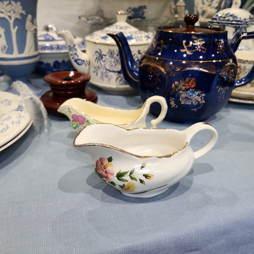A pair of vintage cute snall gravy bowl