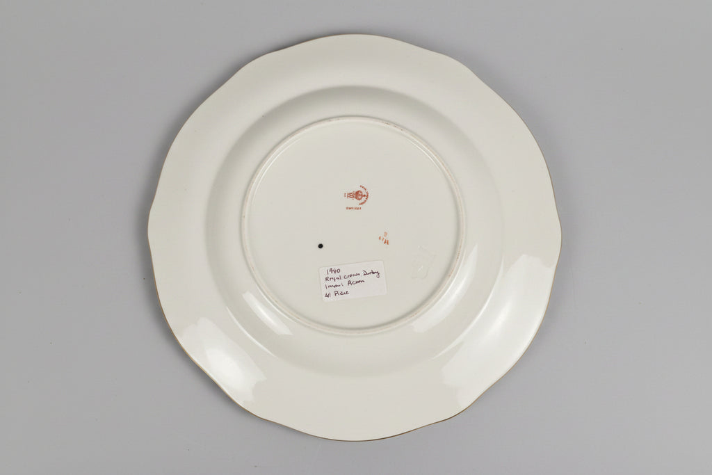 White plate with gold rim on a lace tablecloth