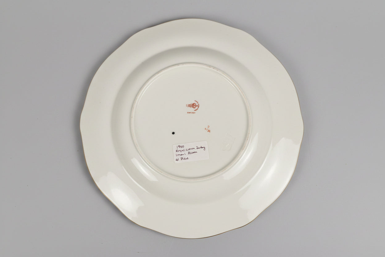 White plate with gold rim on a lace tablecloth