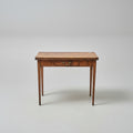 Wooden table with a drawer on a patterned red rug