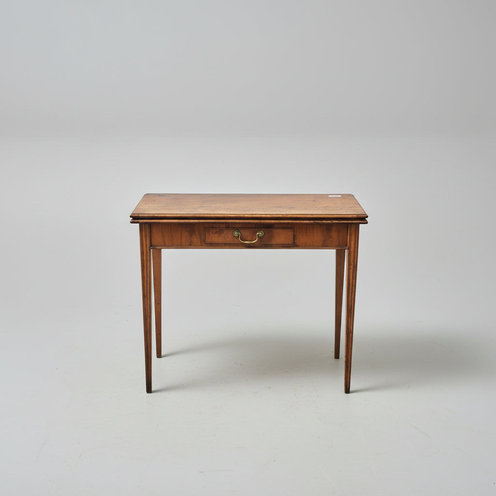 Wooden table with a drawer on a patterned red rug