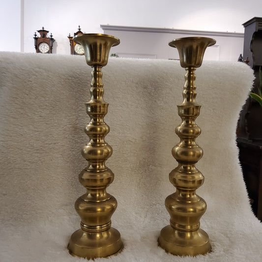 A pair of antique brass candle holder