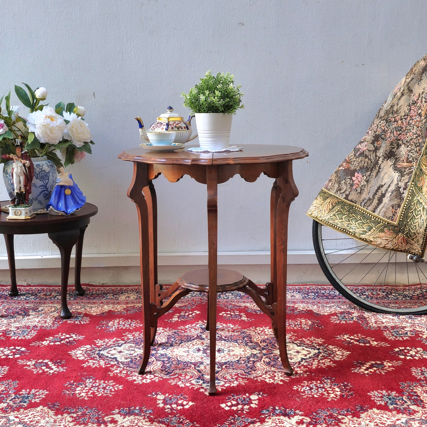 AN EDWARDIAN TWO TIER CENTRE TABLE WITH PIE-CRUST EDGE