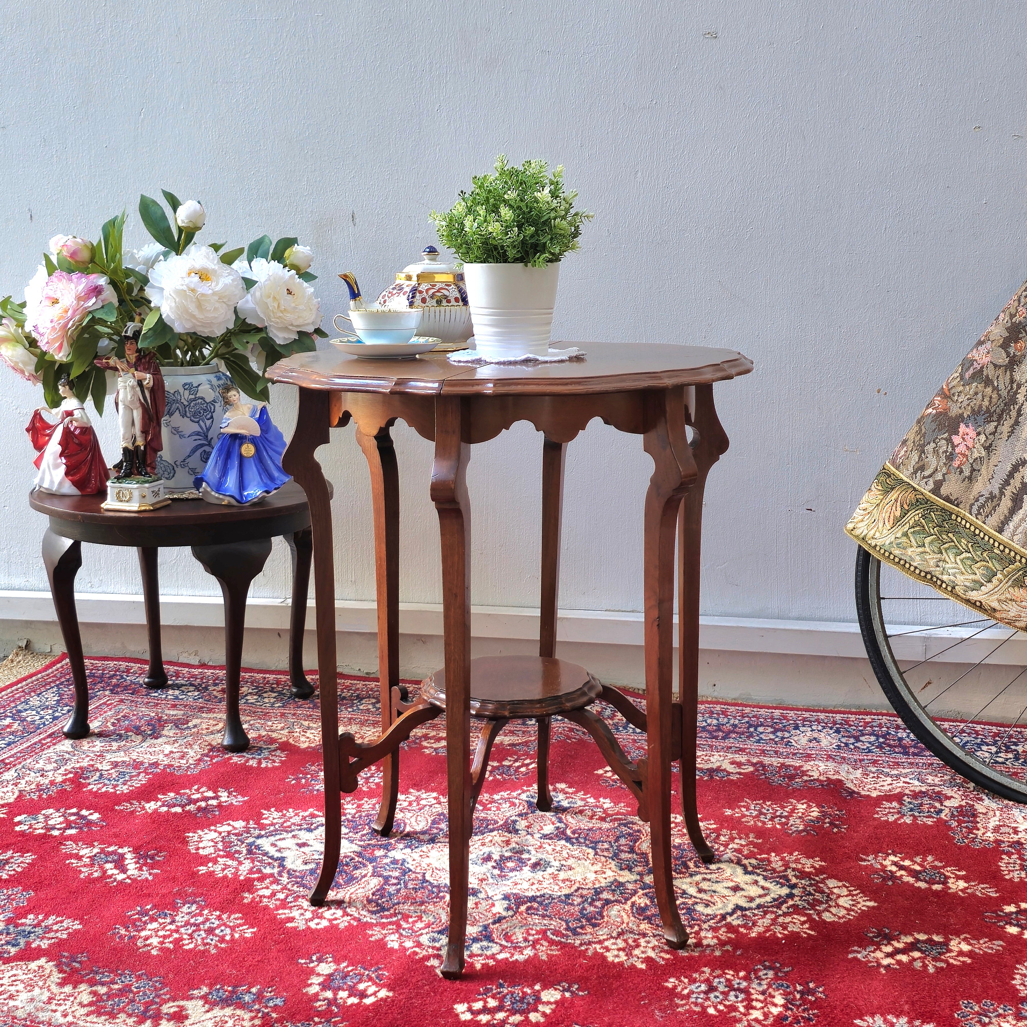 AN EDWARDIAN TWO TIER CENTRE TABLE WITH PIE-CRUST EDGE