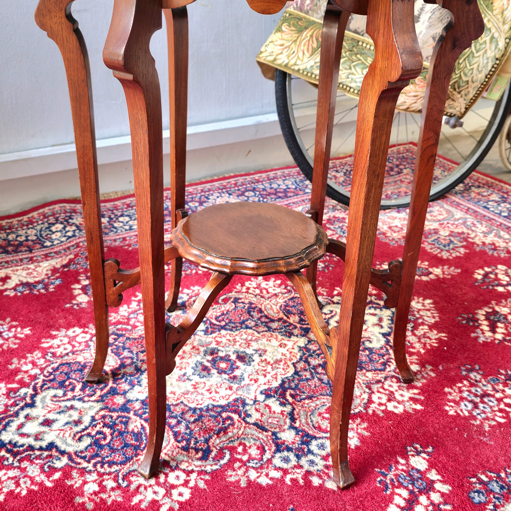 AN EDWARDIAN TWO TIER CENTRE TABLE WITH PIE-CRUST EDGE