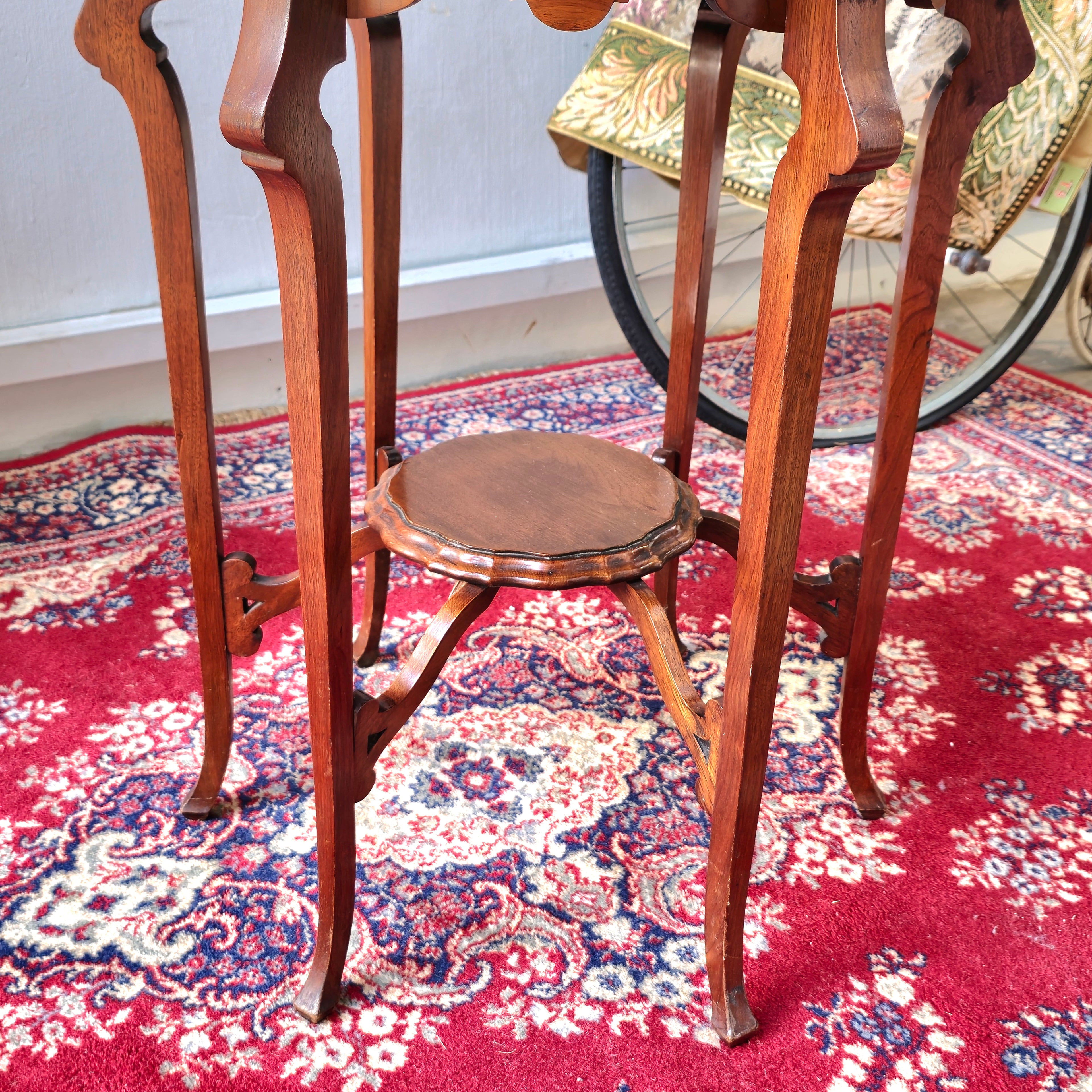 AN EDWARDIAN TWO TIER CENTRE TABLE WITH PIE-CRUST EDGE