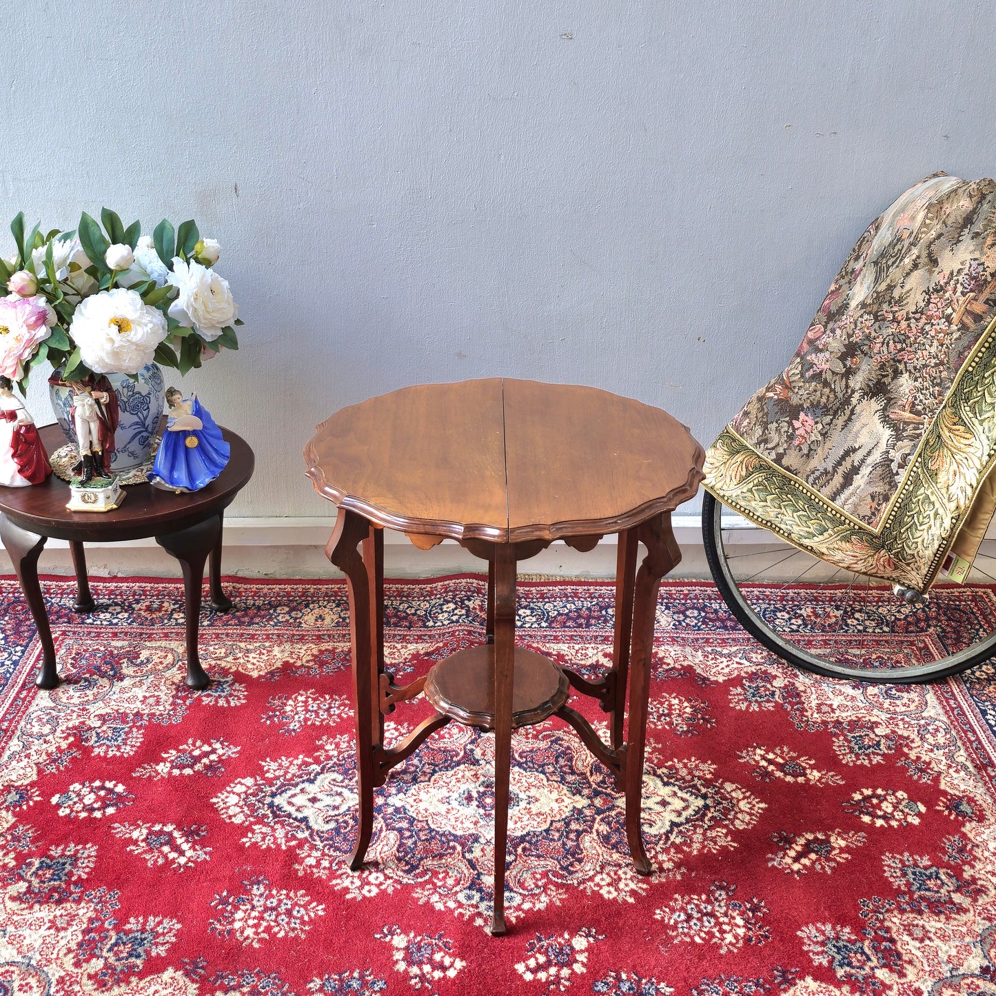 AN EDWARDIAN TWO TIER CENTRE TABLE WITH PIE-CRUST EDGE
