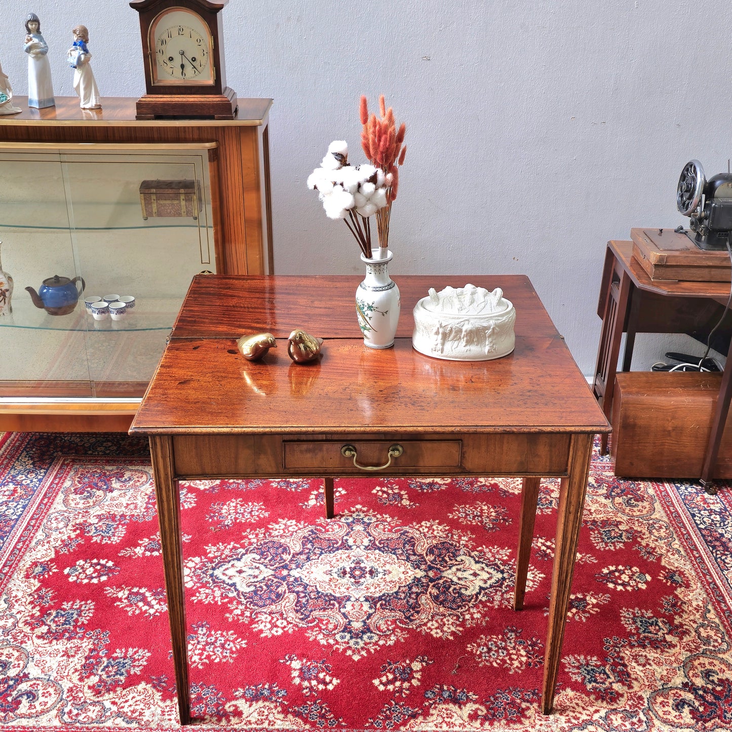 19th Century mahogany fold over tea table, fitted with a small drawer