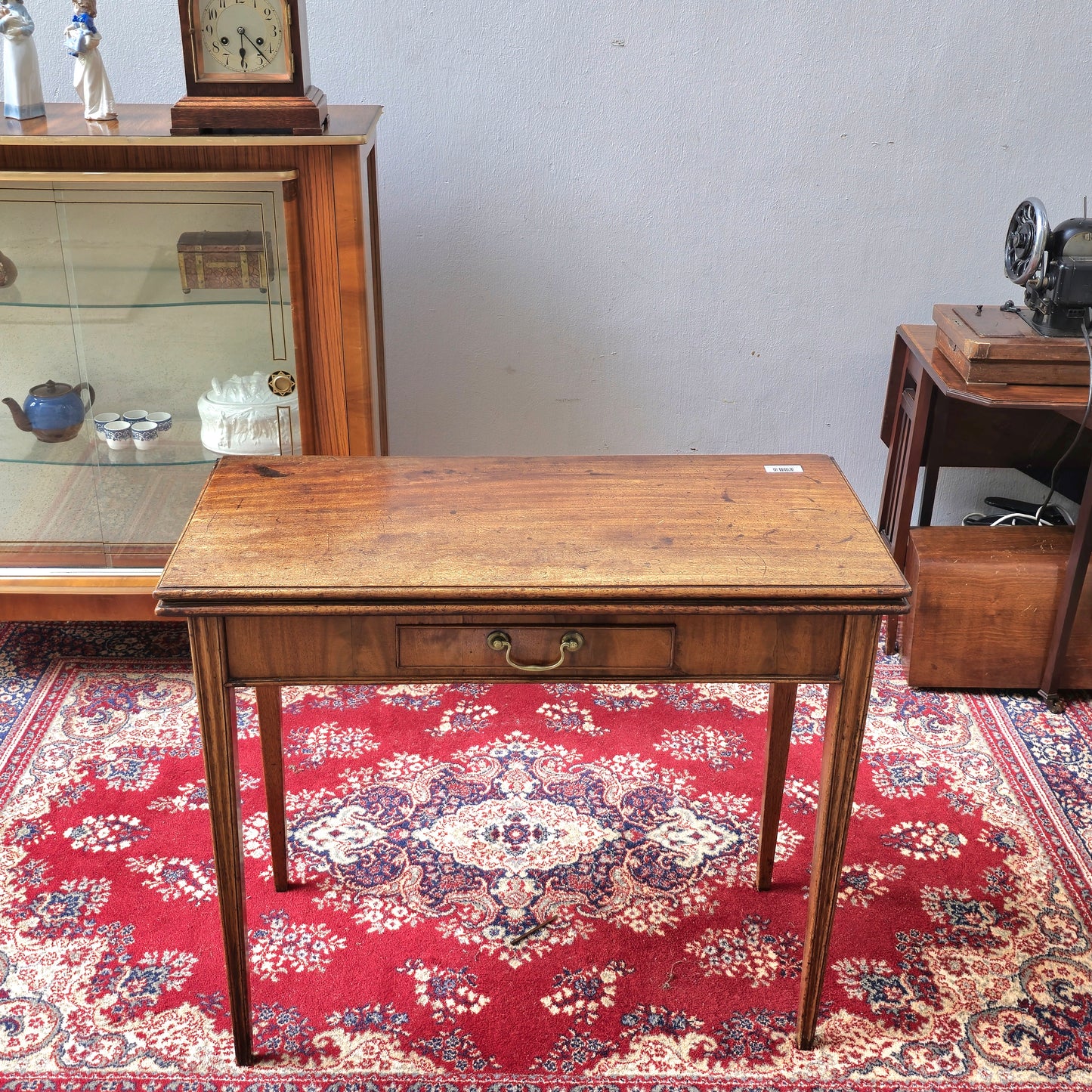 19th Century mahogany fold over tea table, fitted with a small drawer
