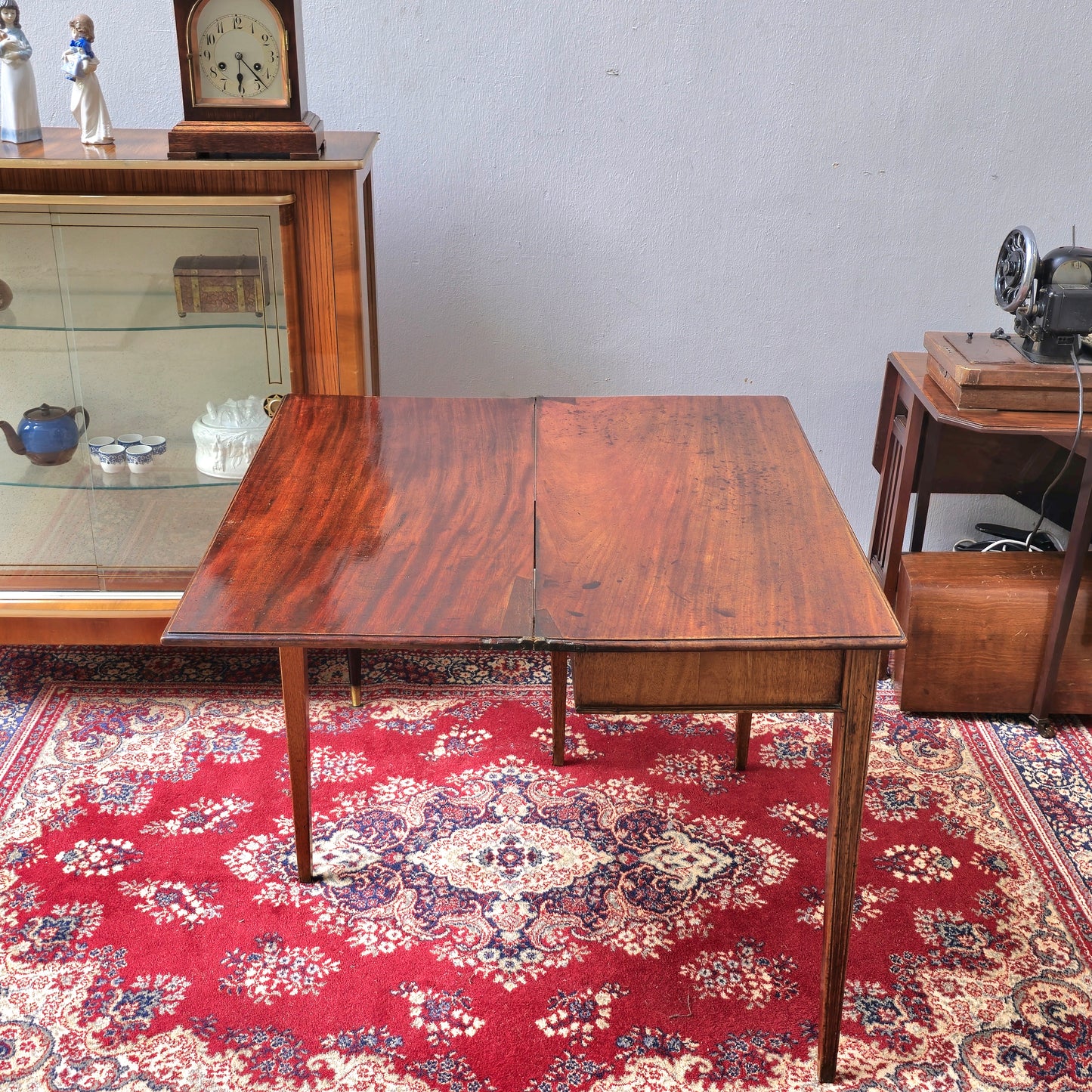 19th Century mahogany fold over tea table, fitted with a small drawer