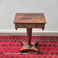 A VICTORIAN ROSEWOOD PEDESTAL CENTRE TABLE WITH SINGLE DRAWER ON BUN FEET, 21.5" X 17"