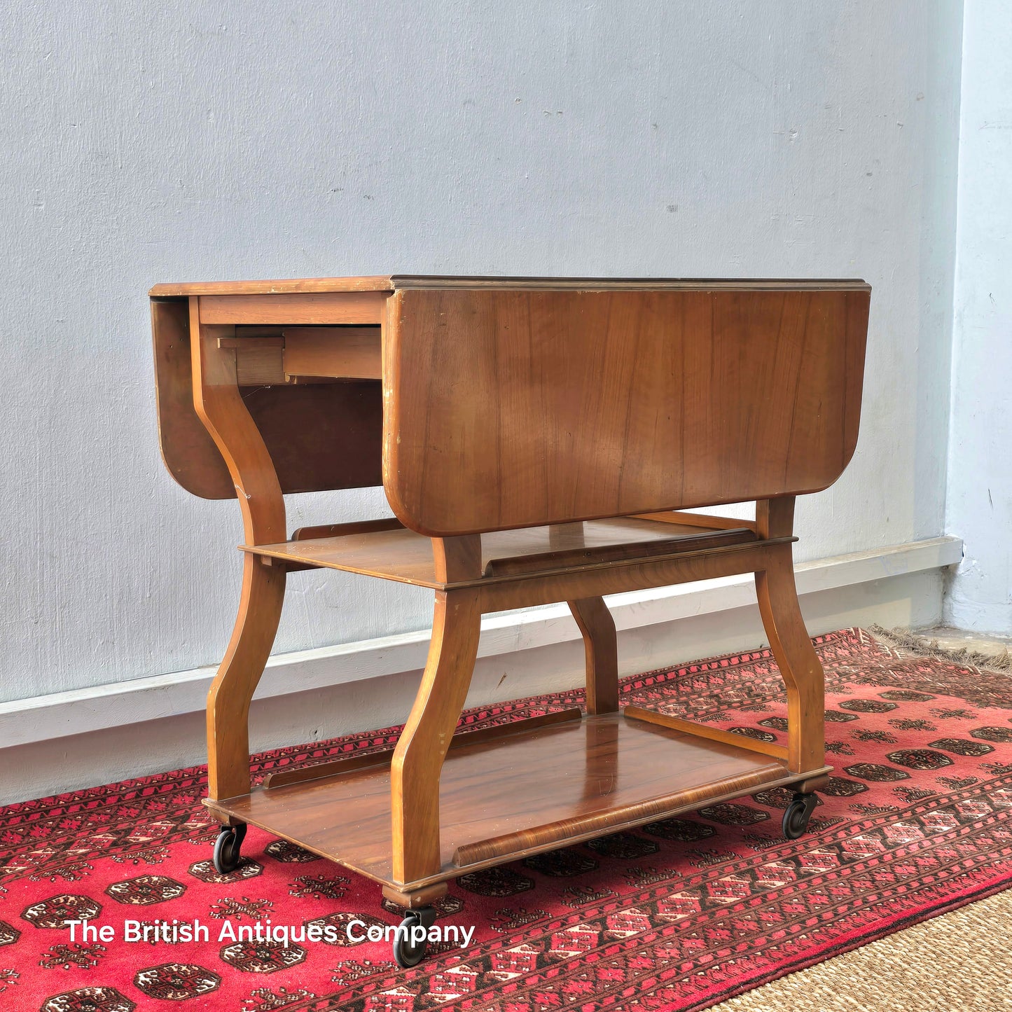 MID 20TH CENTURY WALNUT THREE TIER DROP LEAF TROLLEY BEARING TENAX FREELAND (MANCHESTER) LABEL