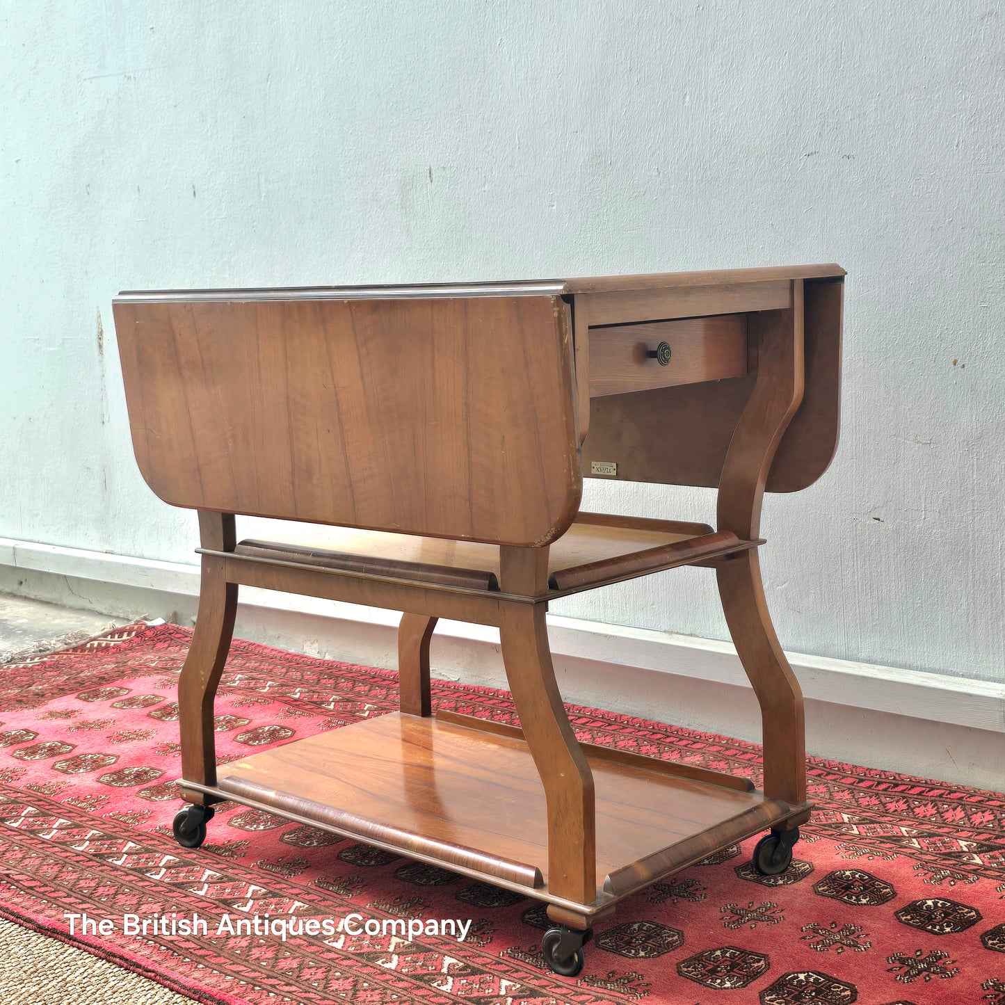 MID 20TH CENTURY WALNUT THREE TIER DROP LEAF TROLLEY BEARING TENAX FREELAND (MANCHESTER) LABEL