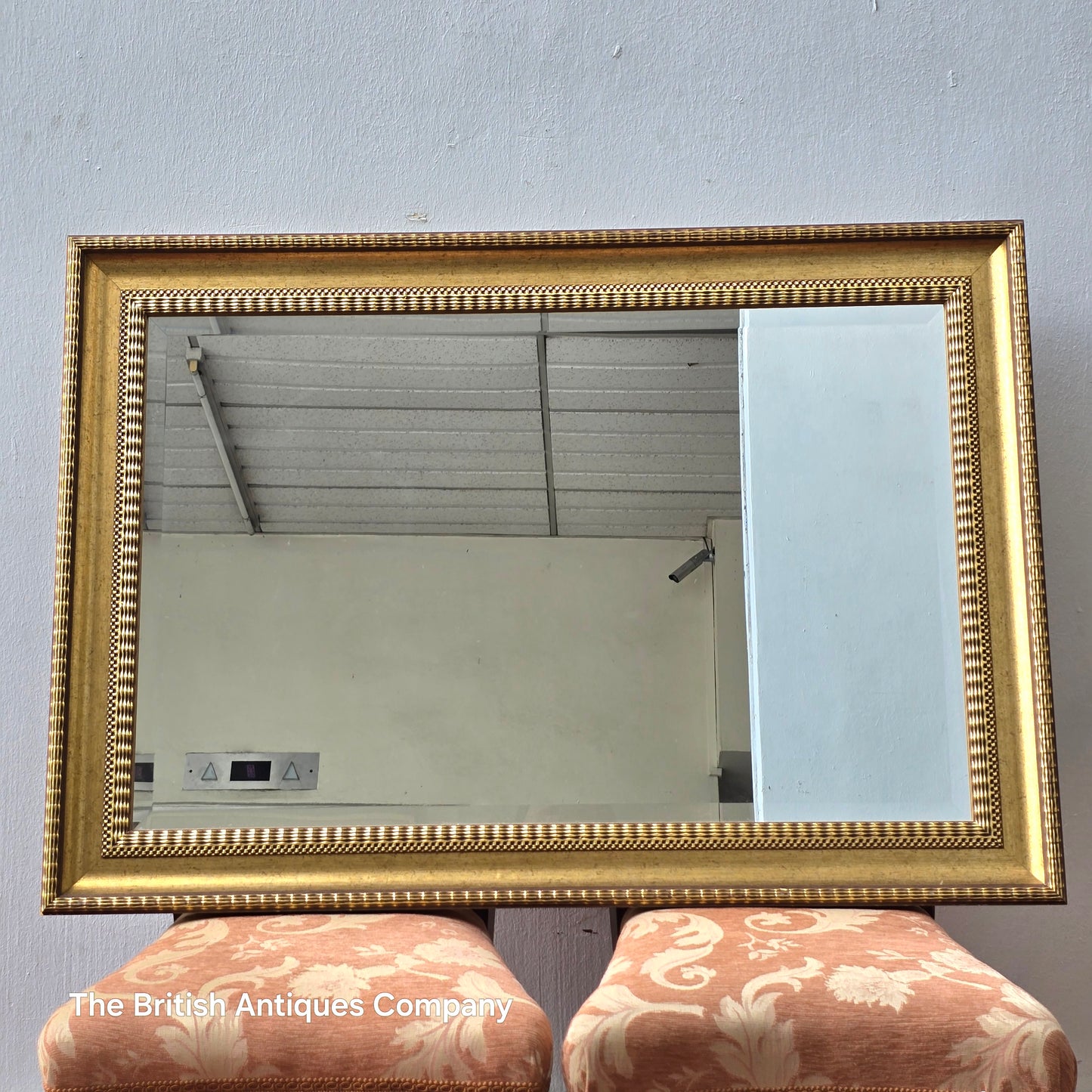 A VINTAGE GILT FRAMED WALL MIRROR WITH BEVEL EDGE, 43" X 33"