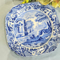 A blue and white floral patterned Spode porcelain plate with a classical architectural border.