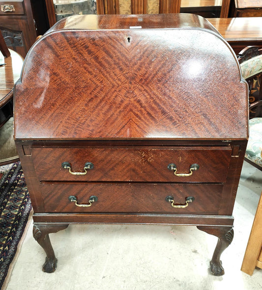 A 1930's mahogany bureau with fitted interior, two shelves below on ball and claw feet