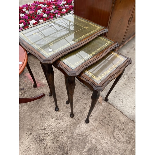 A NEST OF THREE  TABLES ON CABRIOLE LEG Green leather top