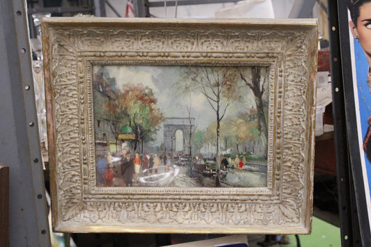 A PRINT OF THE CHAMPS ELYSEES IN PARIS, IN AN ORNATE FRAME