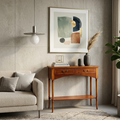 Living room with a wooden console table, abstract art, and a plant.