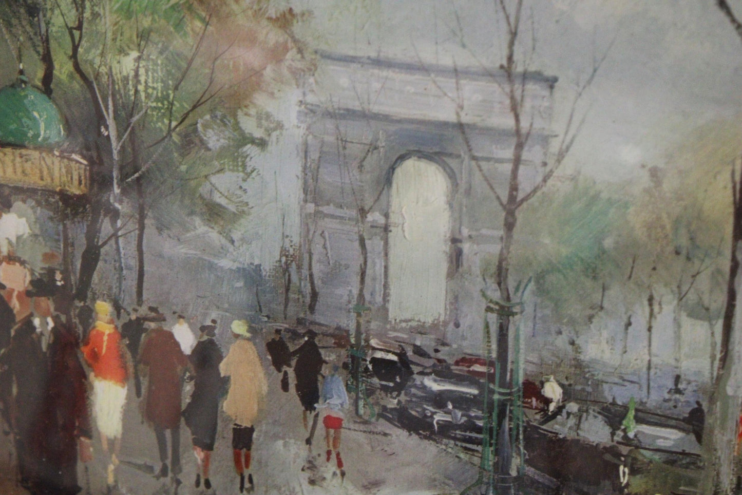 A PRINT OF THE CHAMPS ELYSEES IN PARIS, IN AN ORNATE FRAME