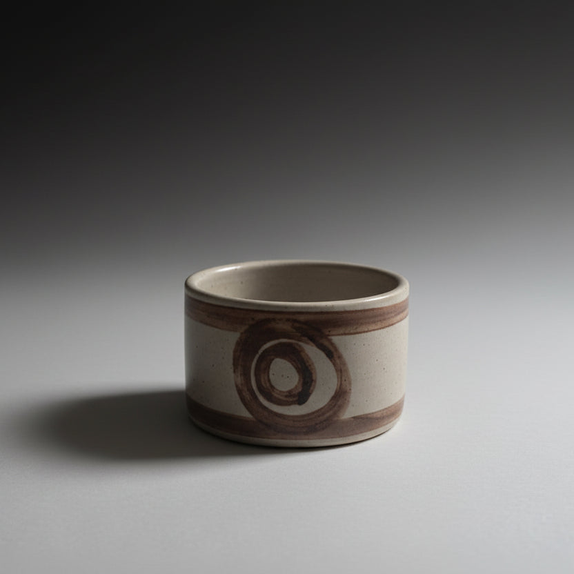 Ceramic pot with a decorative design on a white surface