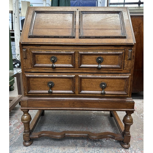 An early 20th century carved oak bureau - approx. 99cm high x 77cm wide x 45cm deep